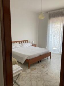 a bedroom with a large bed and a window at Tizi Apartments in Maiori