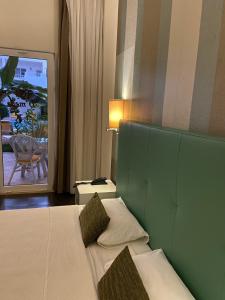 Postel nebo postele na pokoji v ubytování Ouril Pontao Hotel