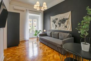 a living room with a couch and a table at Home Out Rooms & Apartments in Lisbon