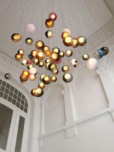 a chandelier hanging from a ceiling in a room at Hotel 1904 in Ålesund