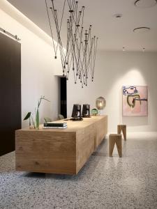 an office with a reception desk with a wooden table at Hotel 1904 in Ålesund