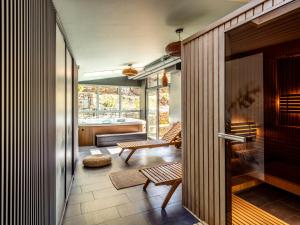 a room with a hallway with chairs and a table at Villa Cam In Ski in Duszniki Zdrój