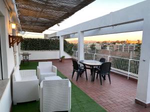 a patio with a table and chairs on a balcony at La Terrazza Imperiale in Rome