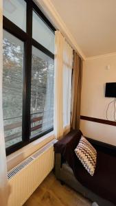 a room with a window and a bed in front of it at Rosheli Apartments in Manglisi