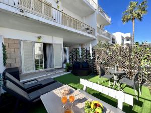 a patio with a table and chairs in a yard at Albufeira Stylish by Homing in Albufeira