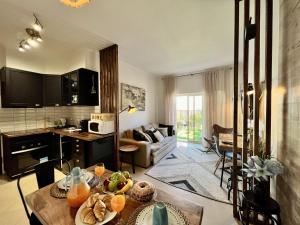 a kitchen and living room with a table with fruit on it at Albufeira Stylish by Homing in Albufeira
