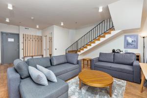 a living room with two couches and a staircase at Gudauri Lodge in Gudauri