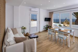 a living room with a couch and a table at Sonus Mare Beach Apartments, Vourvoulos Beach in Vourvoúlos