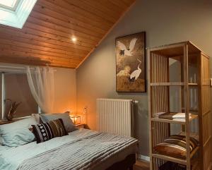 een slaapkamer met een bed en een houten plafond bij Vakantiehuis de Heide in Bergen op Zoom