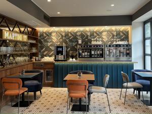 a restaurant with tables and chairs and a bar at Boutique Hotel Martini 17 in Milan