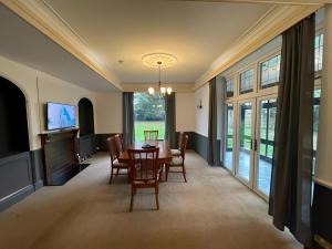 a dining room with a table and chairs and a television at Canford house on Westbury on Trym in Bristol