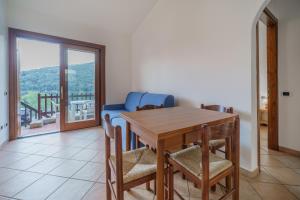 a dining room with a table and chairs and a balcony at La Paolina Vista Mare e Natura in Marciana Marina