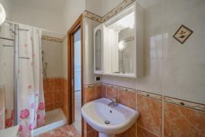 a bathroom with a sink and a shower and a mirror at La Paolina Vista Mare e Natura in Marciana Marina +54 photos