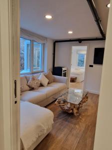 a living room with a couch and a table at Brand New Apartment very cosy and awesome display close to the ski slope! private parking in Sierra Nevada