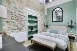 a bedroom with a bed and a stone wall at Cosy apartment 6P - Paris 5 in Paris