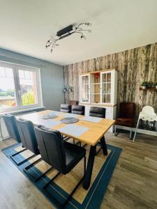 a dining room with a wooden table and chairs at Ferienhaus Markus - Grömitz OT Brenkenhagen in Grömitz