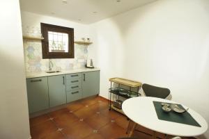 a kitchen with a white table and two chairs at La Cueva in Altea