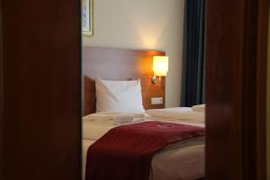 Postel nebo postele na pokoji v ubytování Abasto Hotel Eichenau