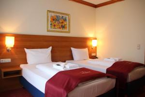 Postel nebo postele na pokoji v ubytování Abasto Hotel Eichenau