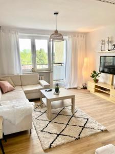 a living room with a couch and a table at Apartament Na Skarpie in Nowy Targ