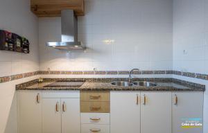 a kitchen with white cabinets and a sink at Calilla de San José in San José