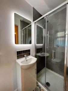 a bathroom with a sink and a shower at Bangor Central Apartments in Bangor