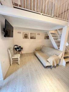 a bedroom with a bed sitting under a loft at La dimora sul porto in Termoli