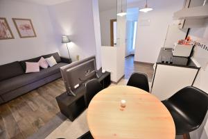 sala de estar con mesa, sillas y sofá en 4 Mares Apartamentos M, en Loredo