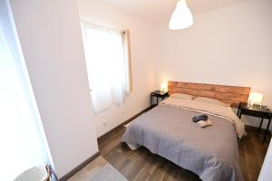 a bedroom with a bed with a stuffed animal on it at 4 Mares Apartamentos M in Loredo