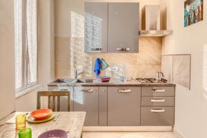 a kitchen with stainless steel cabinets and a table at GINEVRA House in Levanto