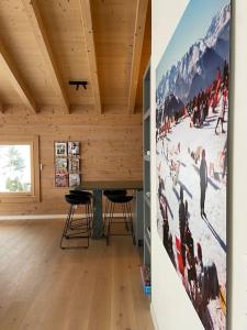 a room with two chairs and a large painting on the wall at Ski in out Swiss Alps Chalet Charelle by Jolidi in Nendaz