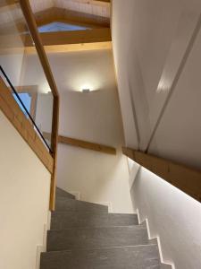 a staircase in a house with a stair case at Ski in out Swiss Alps Chalet Charelle by Jolidi in Nendaz