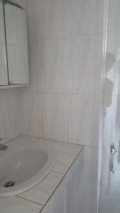 a white bathroom with a sink and a mirror at Studio calme près d’Aubagne in La Penne-sur-Huveaune