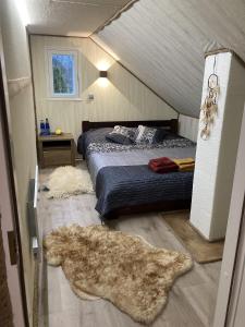 a bedroom with a bed in a attic at Ojaääre puhkemaja 