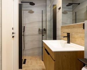 a bathroom with a sink and a shower at Boutique Central old town Apartment in Beer Sheva
