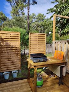 a wooden table with a radio sitting on a patio at Mobile-Home 6 personnes Cap Ferret in Claouey