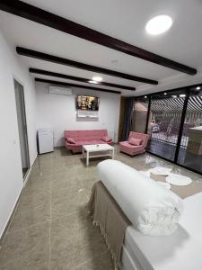 a living room with a couch and a table at Hostel Casa Popa Nan in Bucharest +26 photos