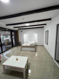 a bedroom with a bed and a white table at Hostel Casa Popa Nan in Bucharest