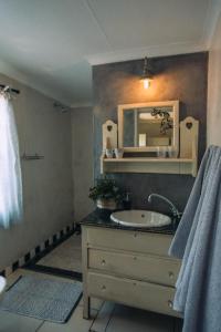 a bathroom with a sink and a mirror at Blue Bell Guesthouse in Tzaneen +23 photos