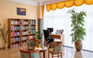 an office with a library with a table and chairs at Kúpele Brusno - LD Poľana in Brusno