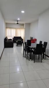 a room with chairs and a table and a couch at Sekinchan Paddy via Seaview Home in Sekincan