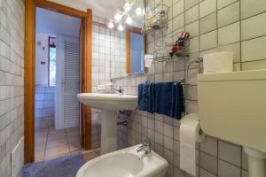 a bathroom with a sink and a toilet and a mirror at Casa Lentisco in Chia +23 photos