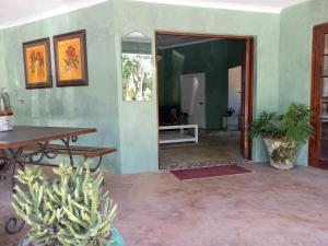a living room with a table and a cactus at Bush Willow Suite - Villa Roc Guesthouse, Salt Rock Ballito Solar Power in Salt Rock