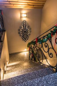 a set of stairs with a christmas ornament on the wall at Willa Golasówka in Muszyna +90 photos
