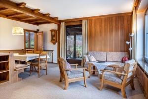 a living room with a couch and a table and chairs at Villa Pinie Apt 1 in Terlano