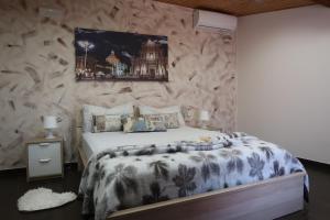 a bedroom with a large bed with a stone wall at casa vacanze mongibello in Nicolosi