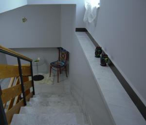 a stairway with a chair and a table at casa vacanze mongibello in Nicolosi