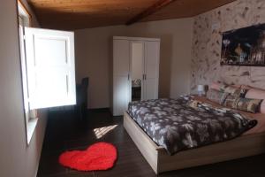 a bedroom with a bed and a red rug at casa vacanze mongibello in Nicolosi +2 photos