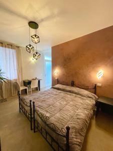 a bedroom with a large bed and a table at Residence Giove in Castelfranco Veneto