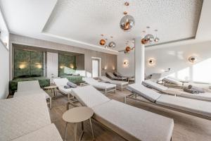 a living room with white couches and chairs at Camping Sölden Apartments in Sölden
